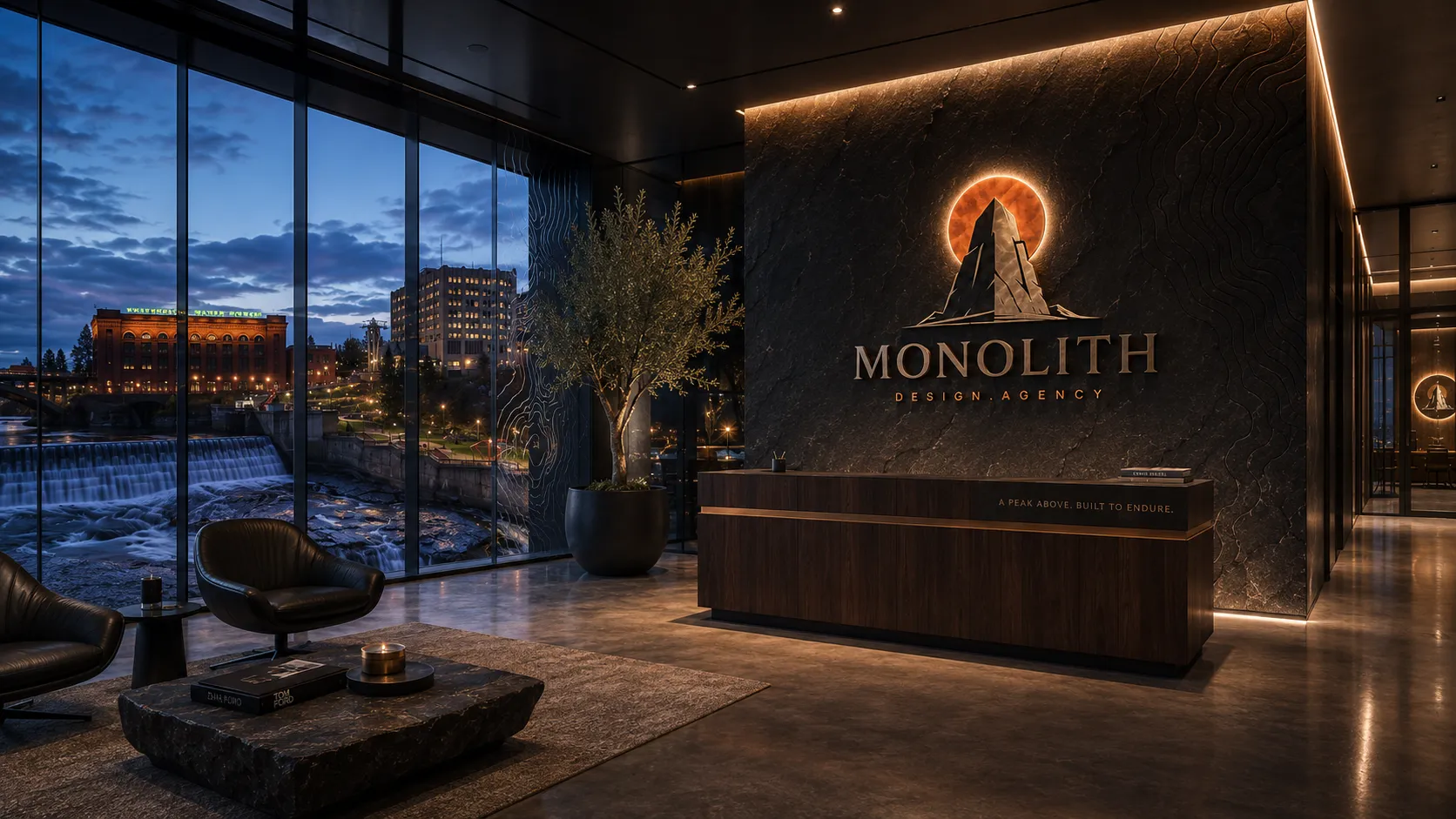 The Monolith lobby in Spokane, logo wall glowing at dusk